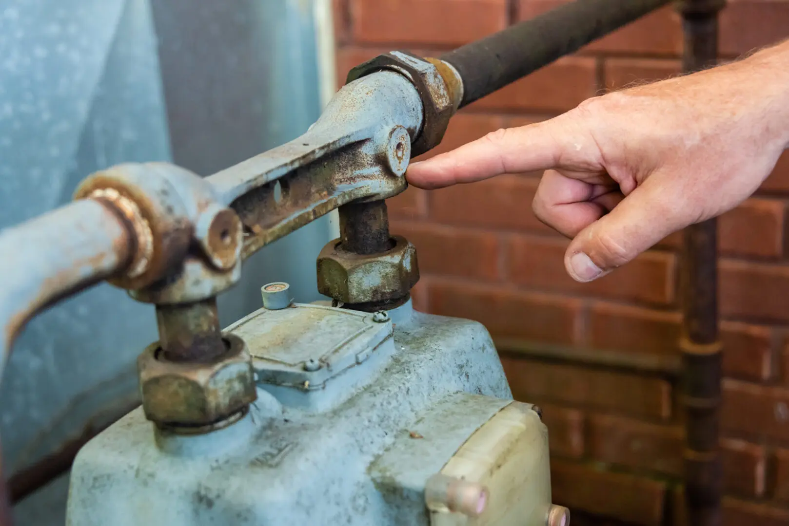 A picture of a person touching a metal pipe